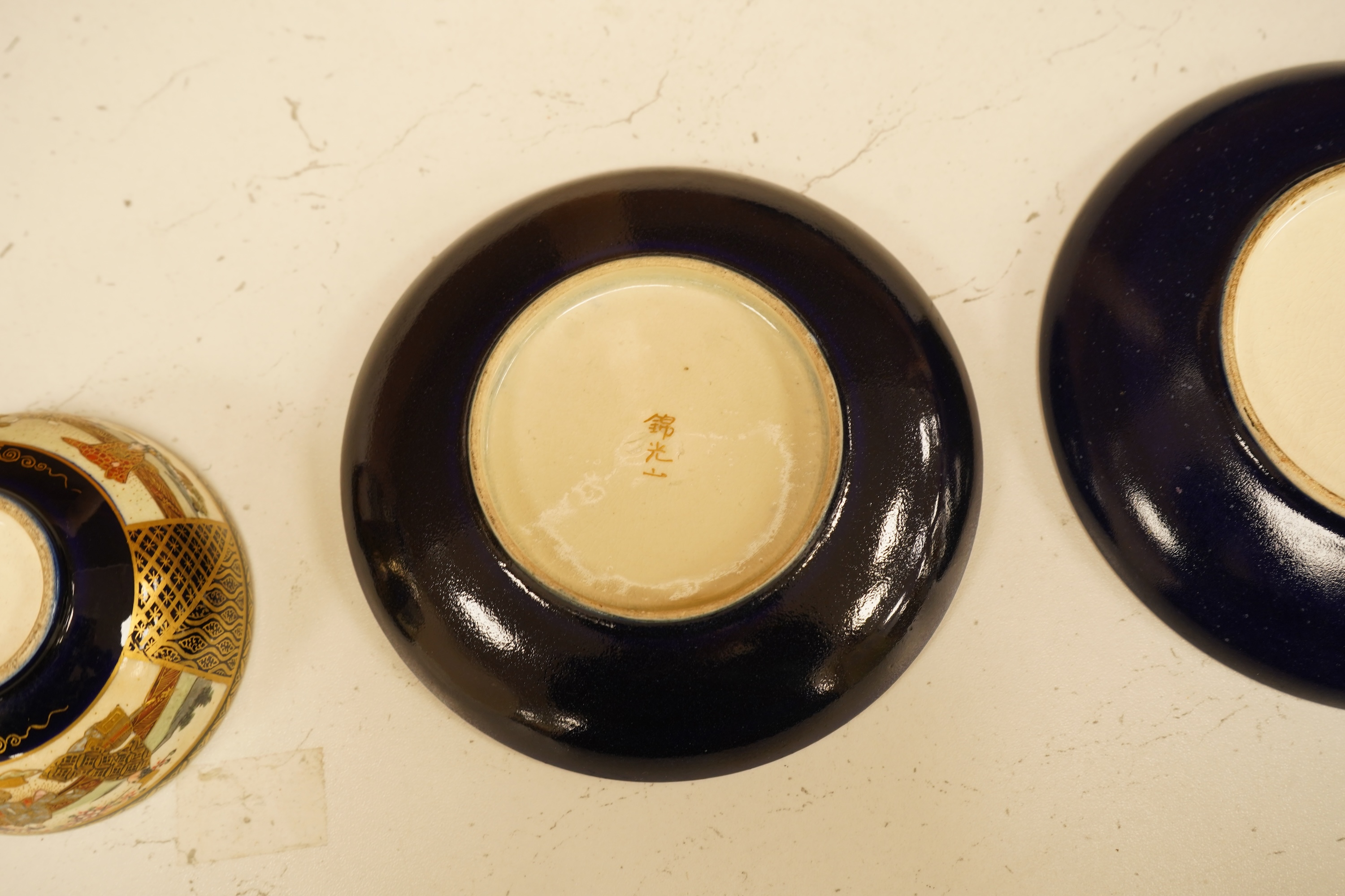 A set of six Japanese Satsuma pottery teacups and saucers, and two further saucers